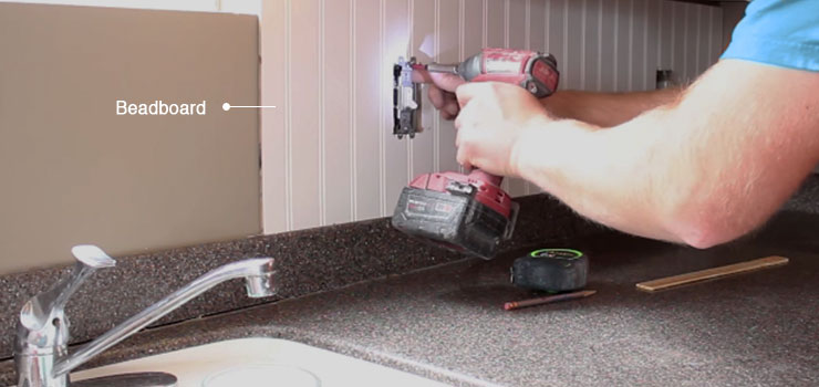 Man installing a Beadboard Backsplash